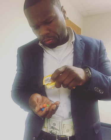 50 Cent eating m&m's with cash stuffed in his waistband