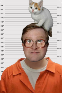 Bubbles from Trailer Park Boys poses for a mugshot with a kitty on his head